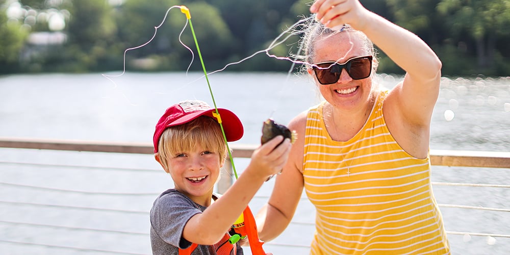 Mother and son catch fish on pier at Lake Ellyn Park